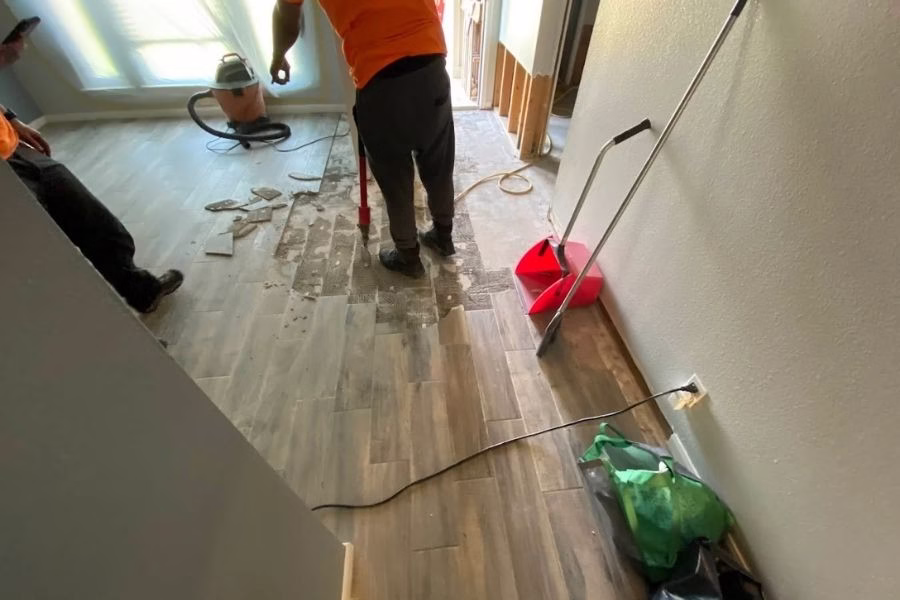 Water damage floor tile removal in progress