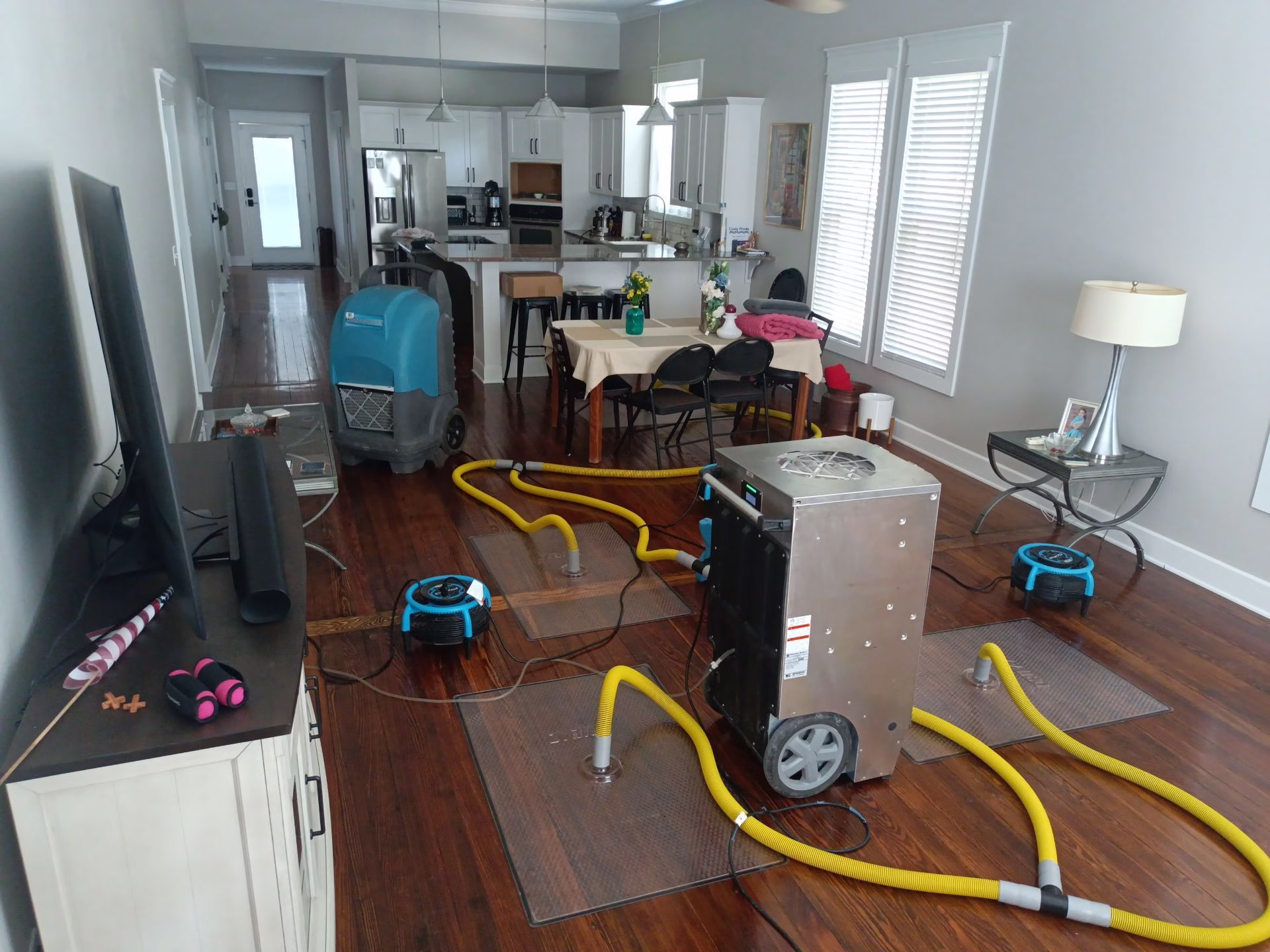 Water damage restoration equipment set up in Smithville home with 100-year-old hardwood floors