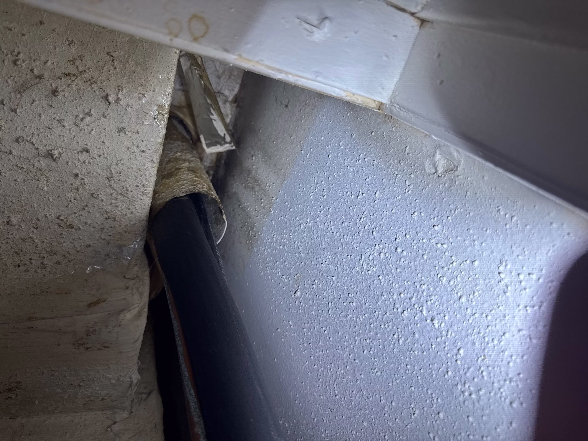 Drain line wall penetration point where water was entering the wall cavity