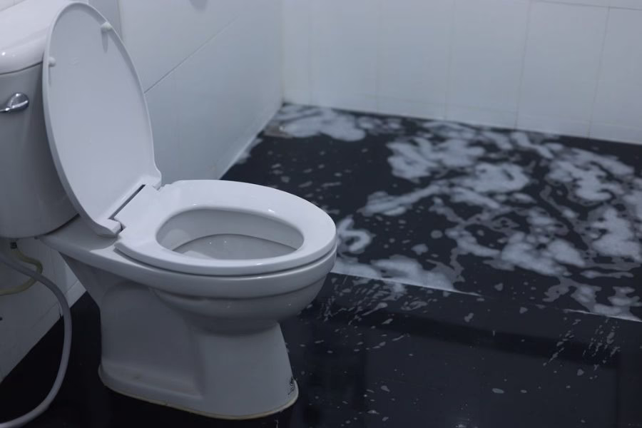 Professional technician performing category 3 toilet overflow cleanup