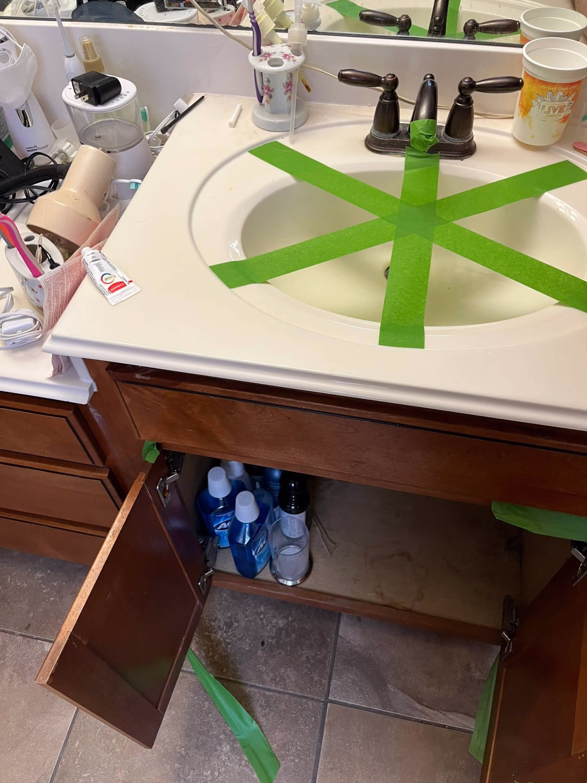 Bathroom sink area taped off and prepped for mold remediation work