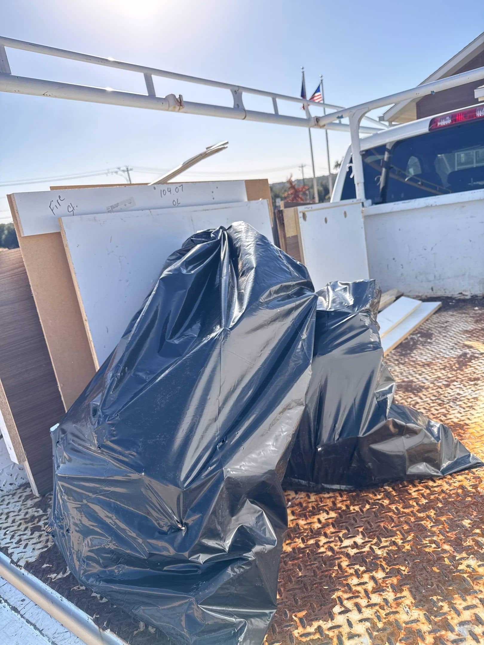 Sealed debris bags of contaminated materials loaded into disposal truck after mold remediation