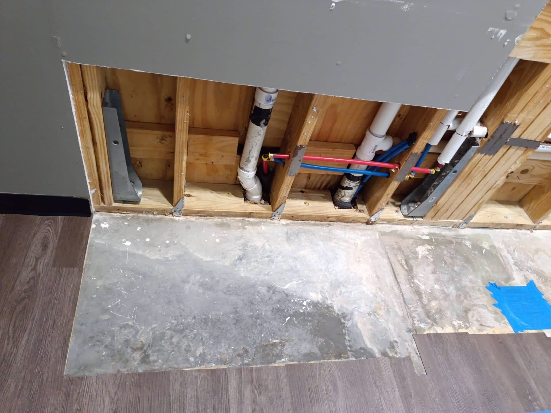 Clean kitchen framing with new plumbing after mold remediation completed in Briarcliff home