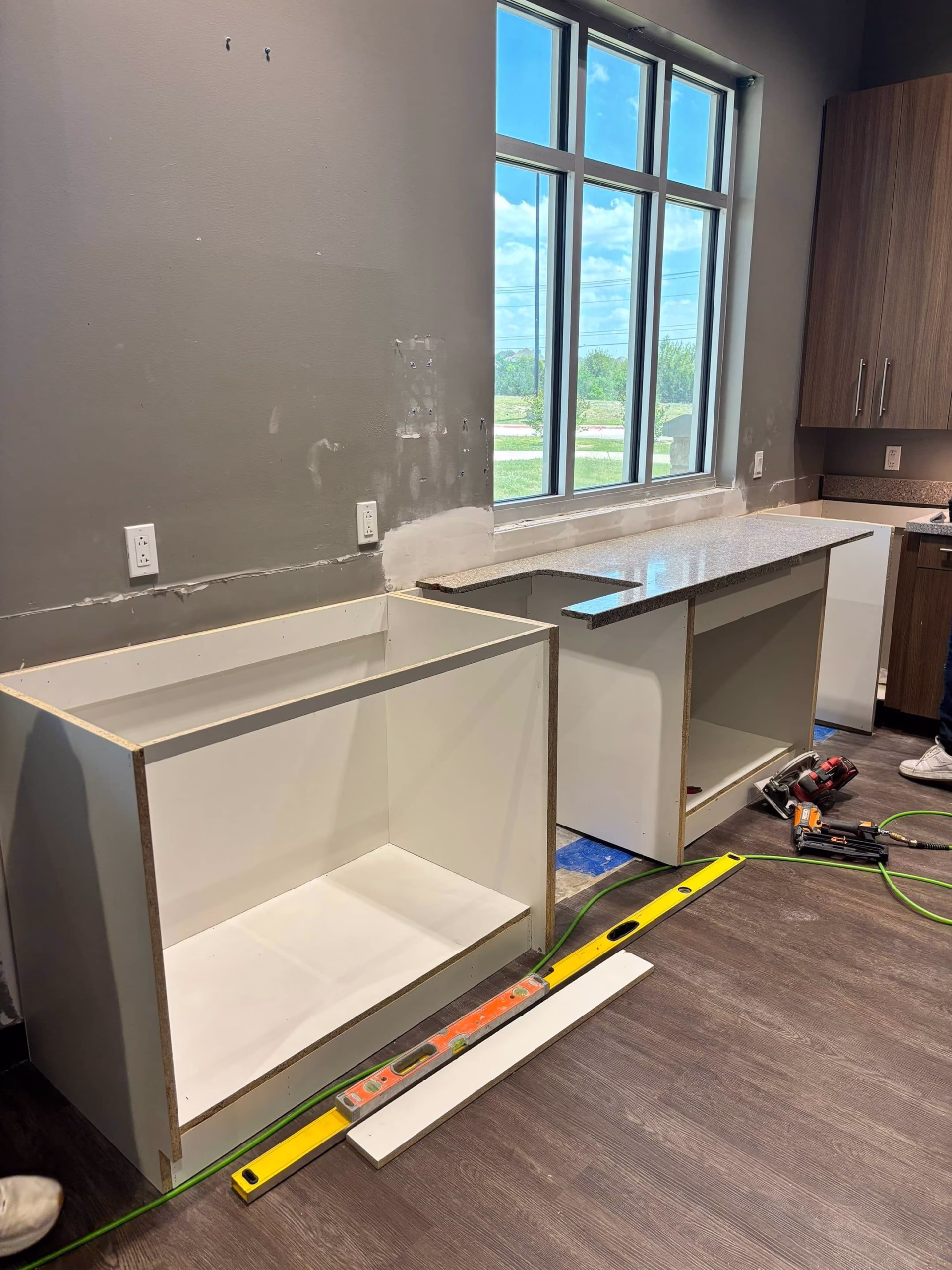 New cabinet installation during kitchen reconstruction progress following mold removal