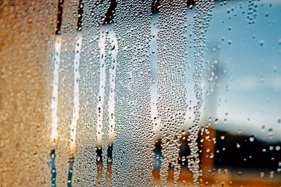 Condensation forming on a window in a Round Rock home during summer humidity
