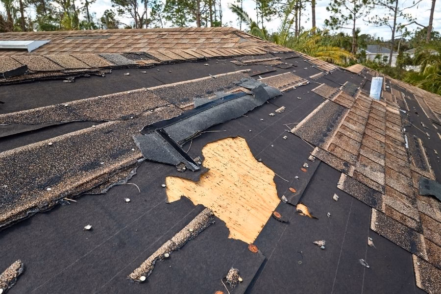Austin home with hail and wind damage after a severe spring thunderstorm, with water intrusion visible inside