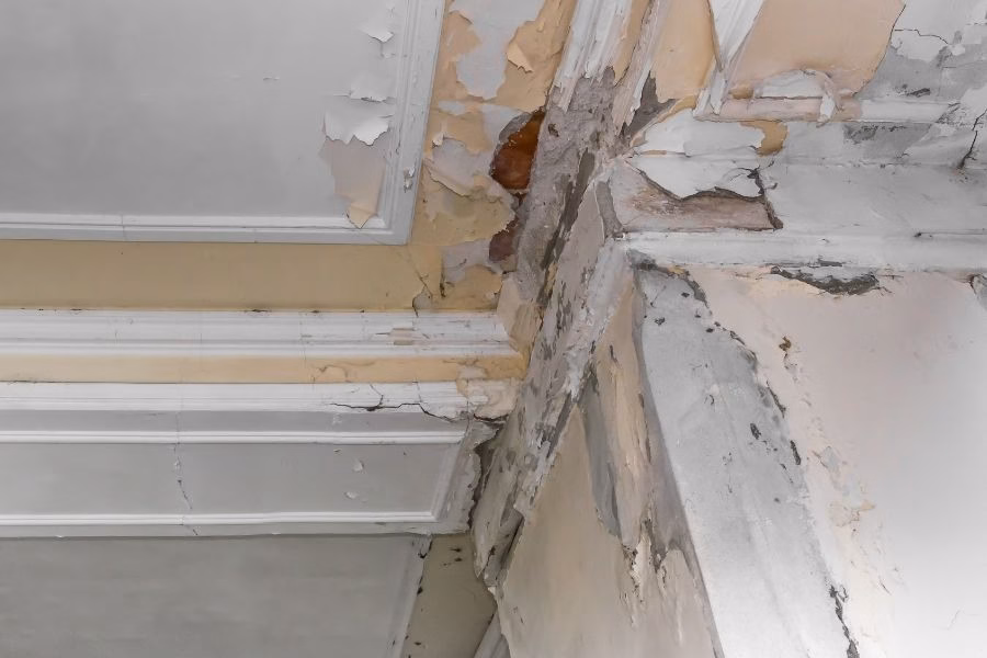 Sagging drywall ceiling bowing under trapped water in a residential home interior